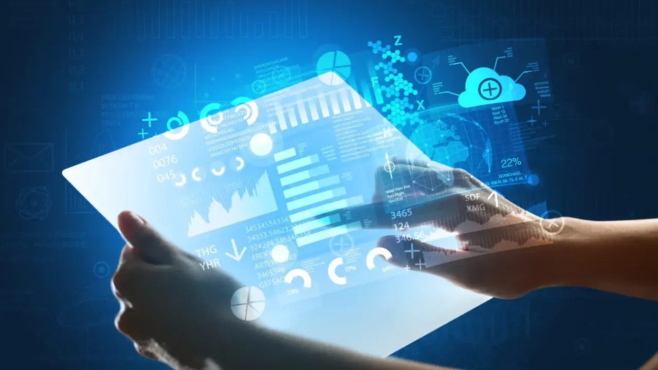 Hands holding a futuristic tablet displaying glowing data, charts, and a globe.