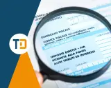 Lente d'ingrandimento su modello fiscale, sezione "Imposte Dirette - IVA", per analizzare l'importo imponibile con o senza IVA.