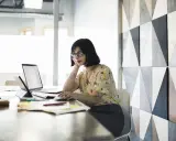 Donna al computer, concentrata, mentre prepara una candidatura spontanea.