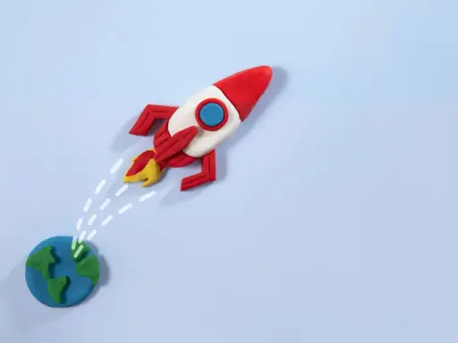 Un razzo di plastilina decolla dalla Terra, pronto per nuove avventure. La risposta a "perché vuoi lavorare con noi" è: per spiccare il volo verso il successo!