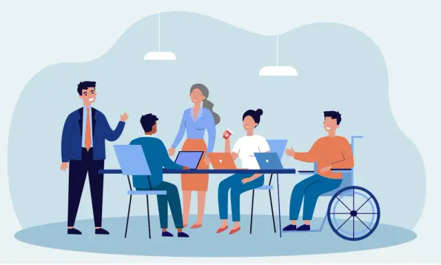 Team di lavoro eterogeneo, con persone di diverse età e un uomo in carrozzina, che collaborano in un ufficio moderno. Esempio di diversity management.